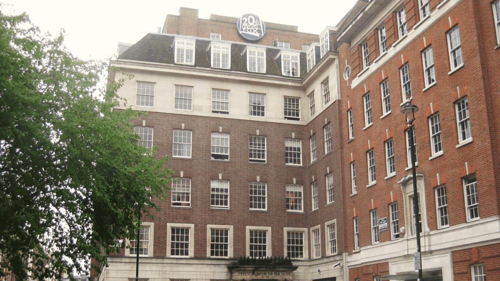 Red brick building with many windows and a "20th Century Fox" sign on the roof.